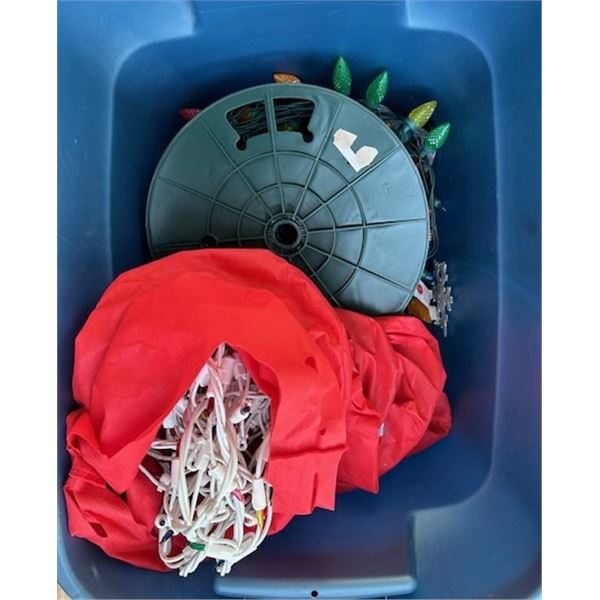 Plastic tub of many Christmas lights - coloured, transparent - and decorations.