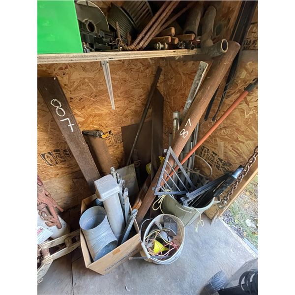 Qty of scrap steel, parts, fuel caps in corner of shed