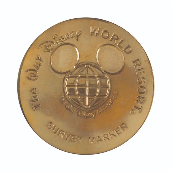 A Walt Disney World Survey Marker Paperweight.