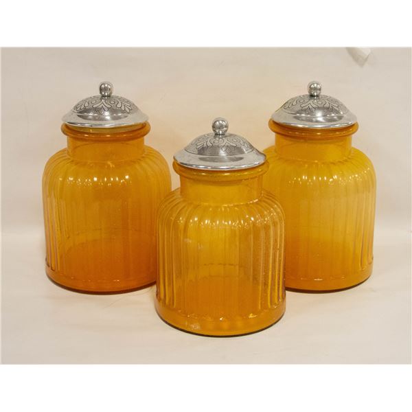 A SET OF THREE AMBER COLOR JARS WITH SILVER COLOR
