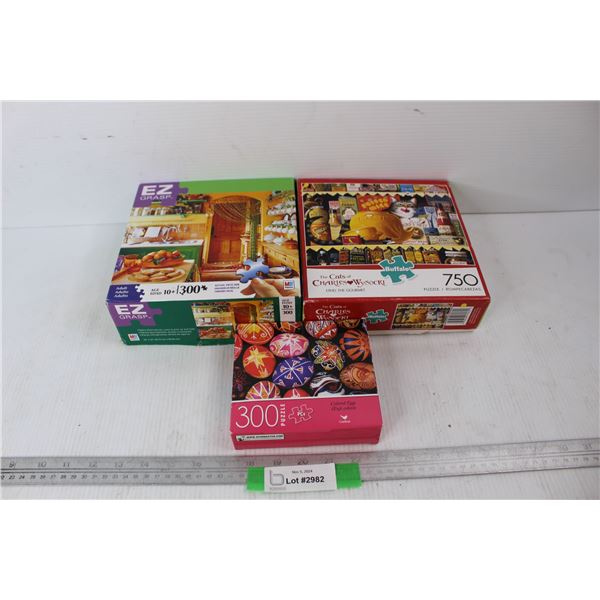 (2) 300 Piece Jigsaw Puzzles, (1) 750 Piece Jigsaw Puzzle
