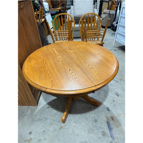 pedestal table and four chairs with one leaf