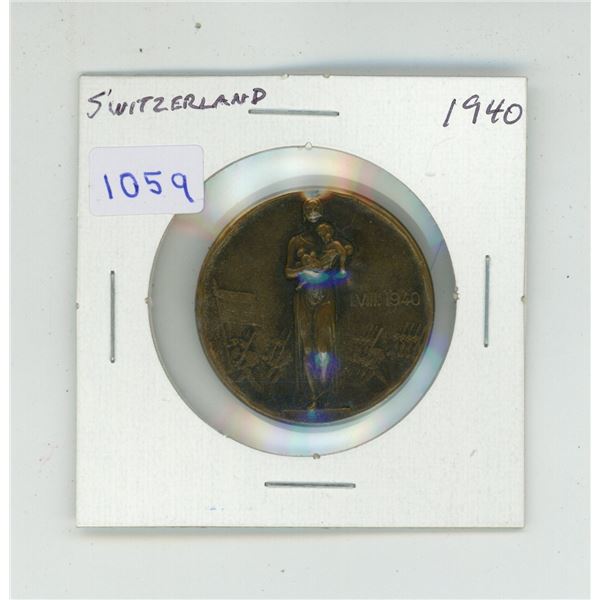 Switzerland. 1940 bronze medal. Depicts a woman & child with soldiers marching. Marked Huguenin Le L