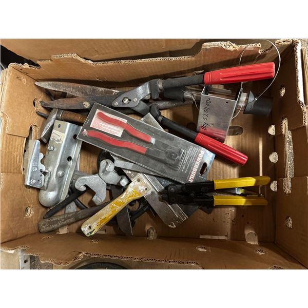 Box of assorted tools and trailer hitches.