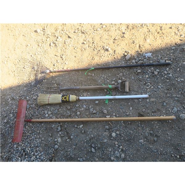 two rakes a broom and a pitch fork