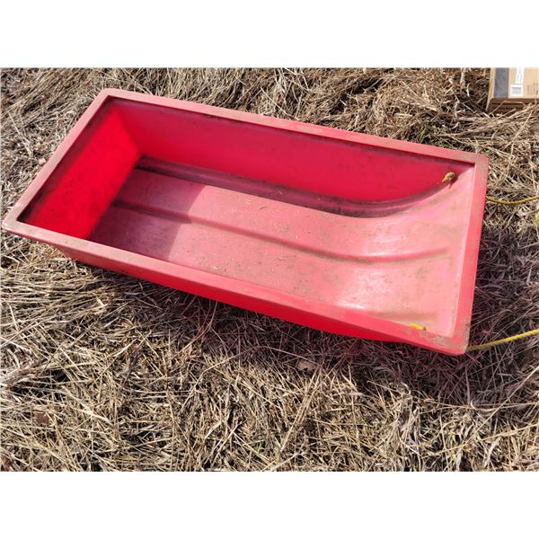 Red plastic calf sleigh