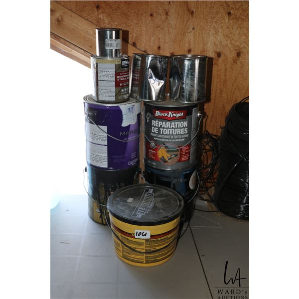 Selection of assorted paints, stains, and stucko patch.