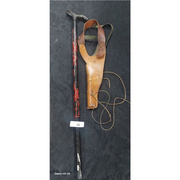 Vintage leather gun holster and carved walking stick