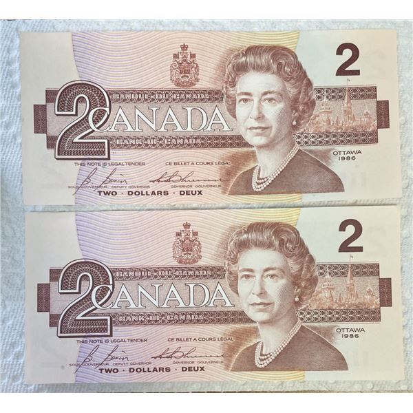 2 crisp uncirculated 1986 Canadian Bird Series two-dollar bank notes.