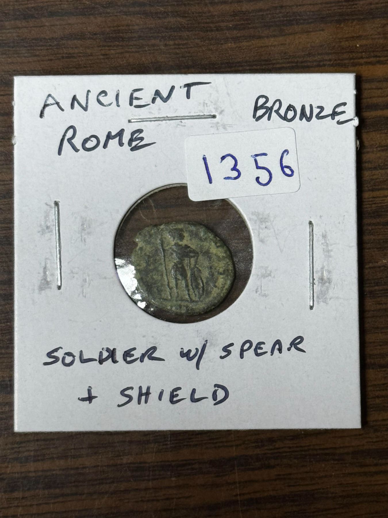 Ancient Rome. Unattributed bronze Roman coin. Reverse depicts a soldier ...