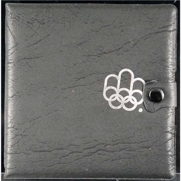Error; 1976 Olympic set, includes 4 silver coins (1974).  Olympic logo on black leather case shifted