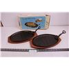 (2) Cast Iron Steak Platter with Lifters And Wooden Hot Plates