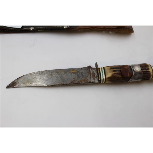Hunting knife in sheath with lion head handle