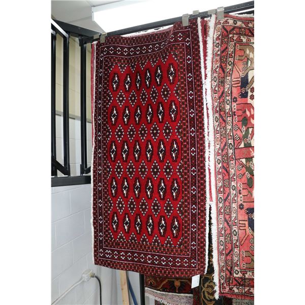 100% hand made Iranian wool throw rug with red background, overall geometric pattern in colours of b