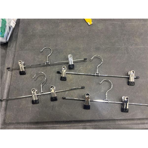 Lot of 4 clothing hangers with clips