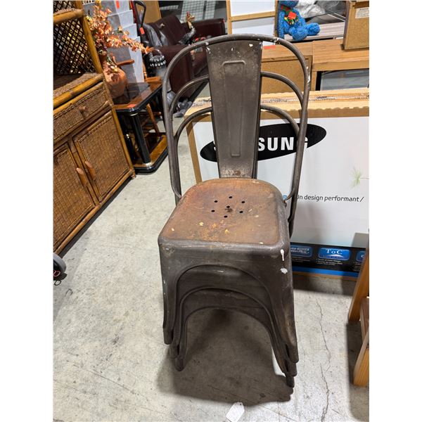 Three rustic metal chairs