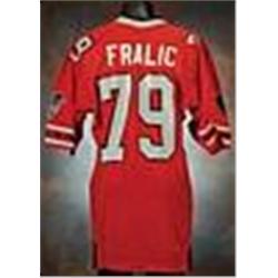 On the front left tail of the jersey is the "Russell" size 46 manufacturer's tag. Above this is the 