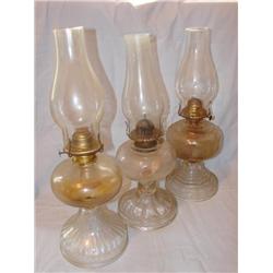 3 oil lamps, all with chimneys.