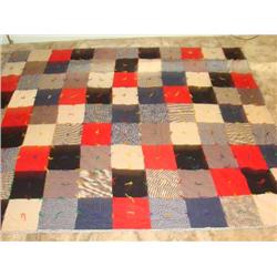 Hand tied wood/flannel block quilt.