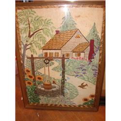 Framed behind glass, handstiched work.