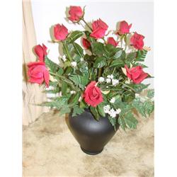 Rose floral arrangement in black pottery vase.