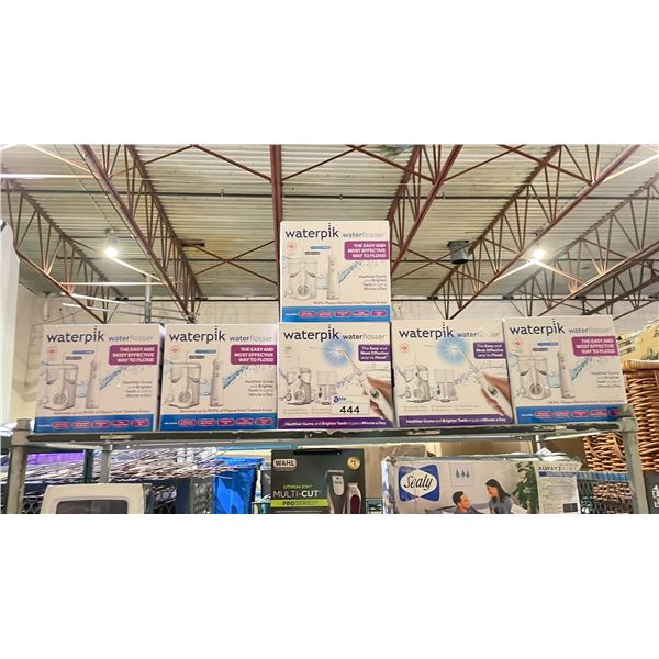 SHELF OF ASSORTED WATERPIK WATER FLOSSERS (UNKNOWN WORKING CONDITION, MAY BE MISSING PARTS &