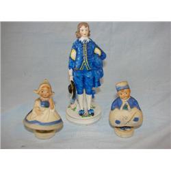 3 figurines, tallest one is Occupied Japan