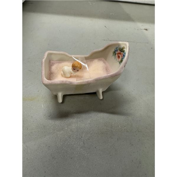 Miniature baby in  cradle signed