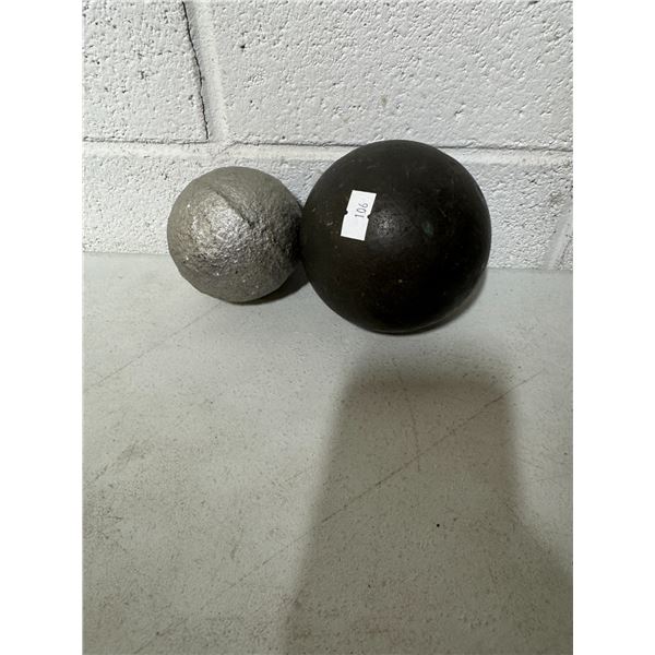 2 Cannon balls, one black one painted silver