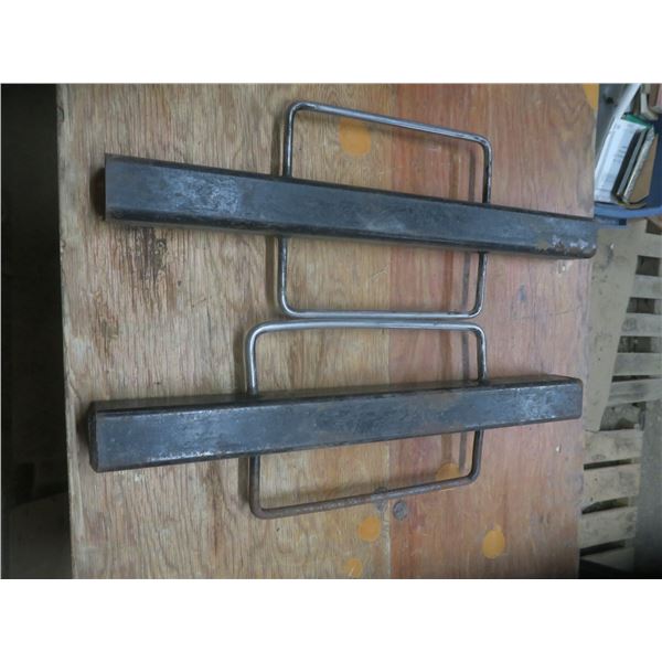 two metal brackets with handles