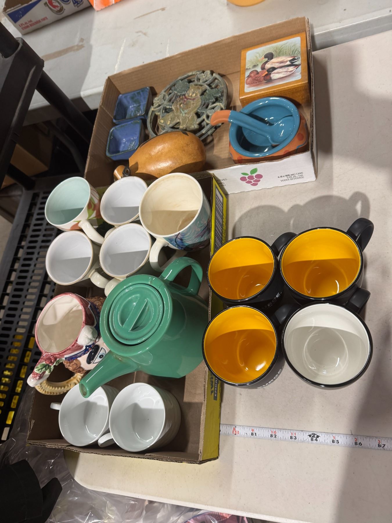 Assorted kitchen items, mugs, trivets, etc.