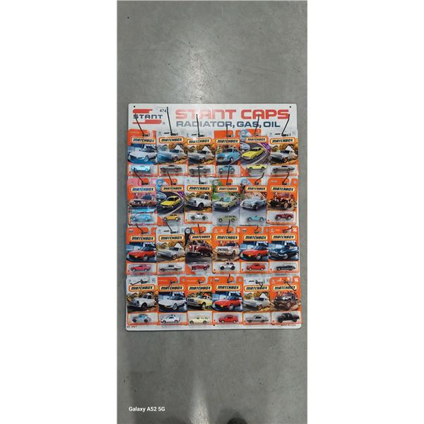 Vintage stamped stant caps peg display board with 24 assorted matchbox cars 24"x32"