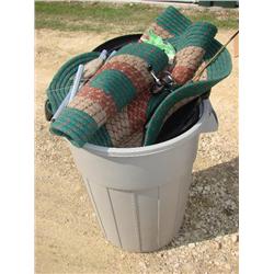 Trash can w/lid, full of rugs,chimes,rod & reel