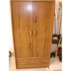 Cabinet with clothes hanging rod
