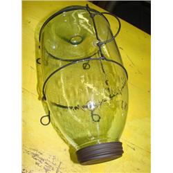 Old glass minnow trap on metal stand