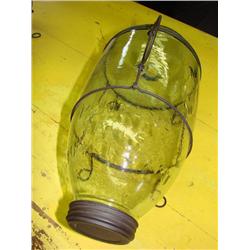 Old glass minnow trap on metal stand
