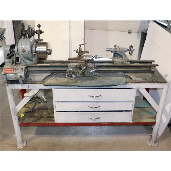 ATLAS METAL LATHE ON WORKBENCH WITH TOOLING AND SOME