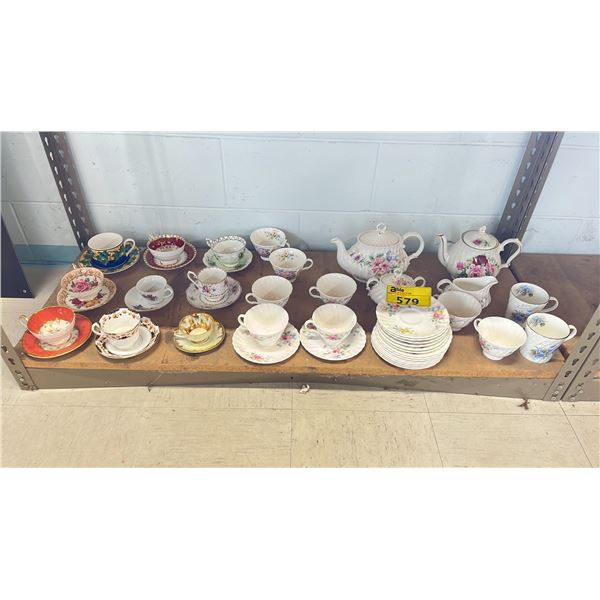 SHELF OF ASSORTED TEA SAUCER, CUPS, TEA POTS. INCLUDING PARAGON, ANSLEY, STAFORD, ROYAL ALBERT &