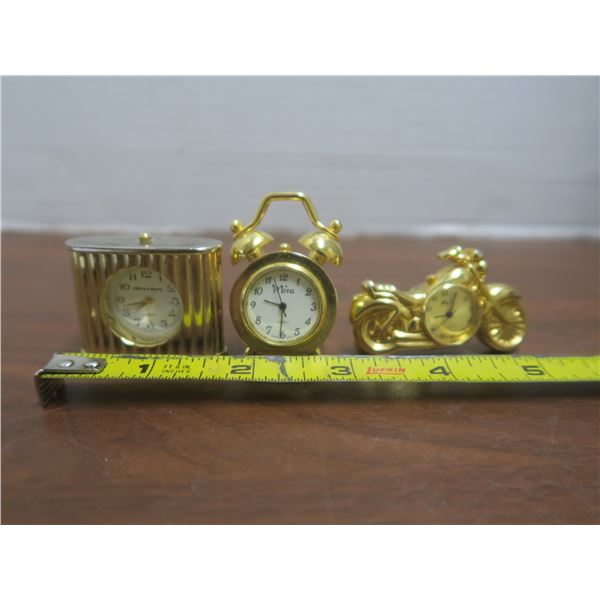 three miniature clocks