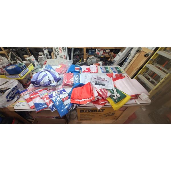 LARGE BOX OF NEW AND USED FLAGS ROUGHLY 25 NEW AND 25 USED