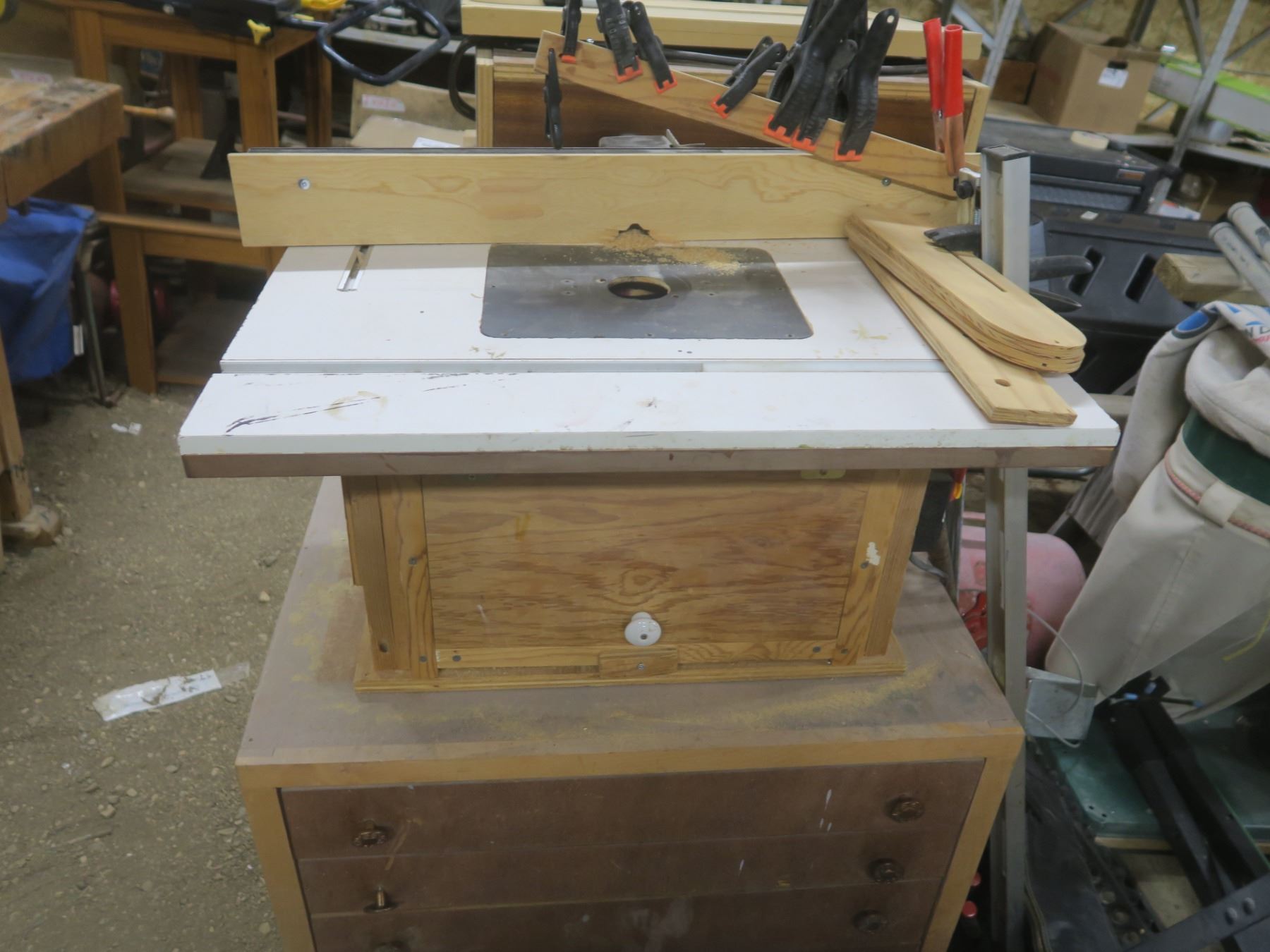Router table on four drawer rolling cabinet. Table includes a Jessem ...
