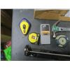 Image 3 : caulking gun, hammer, measuring tapes, laser level, stud finder