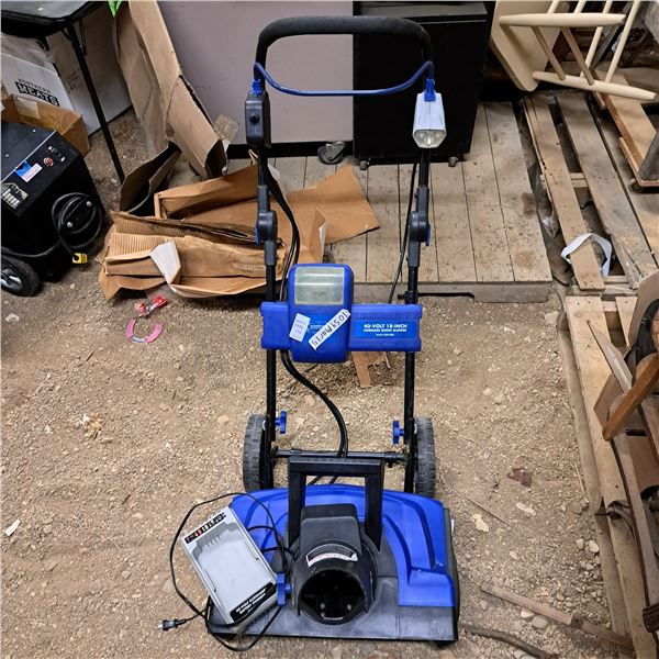 Small blue snow blower with battery charger