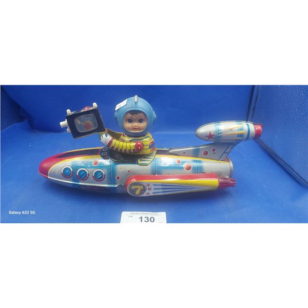 Large 1960s tin toy rocket ship with boy holding camera