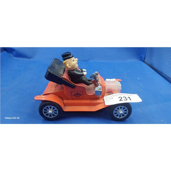 Vintage tin toy man in orange car, made in Japan
