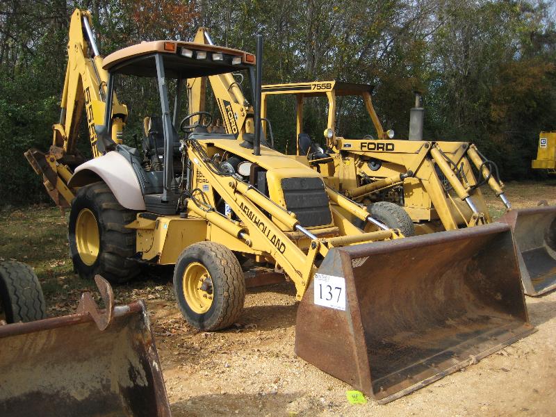 NEW HOLLAND 555E LOADER BACKHOE J.M. Wood Auction Company, Inc.