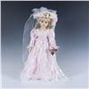Image 1 : Large Porcelain Doll with a Corsage