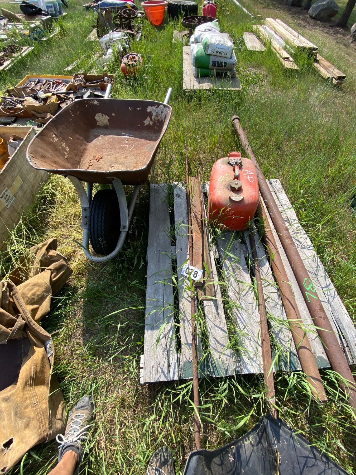 AP pallet with a Fuel Tank , misc angle iron , pipe , crowbar & wheel ...