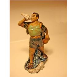 Porcelain Man Blowing Shell