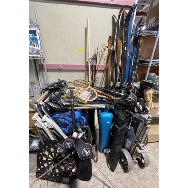 Group of assorted sports gear includes skis/poles, golf clubs/bag, fishing rods, folding chairs, bik
